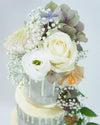 Grey drip cake decorated with fresh flowers - Tuck Box Cakes